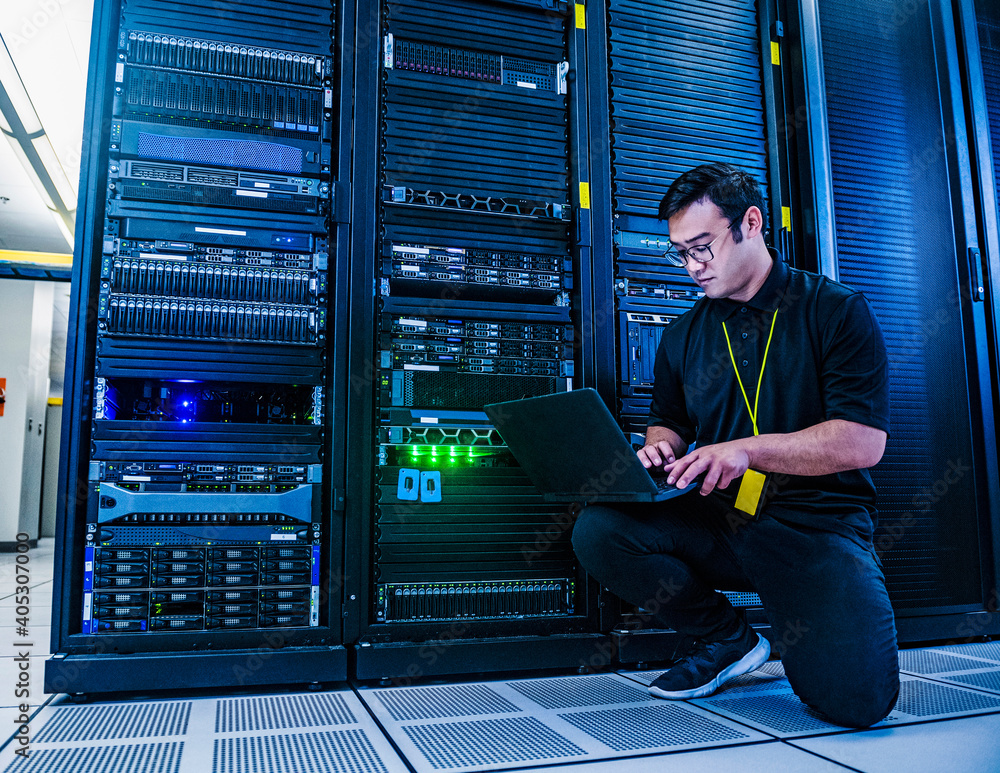 © Erik Isakson - Employee working on server rack in data center