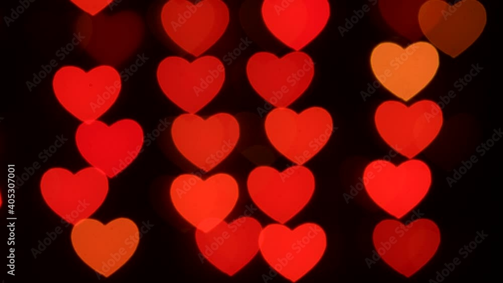 Red and yellow hearts sparkle on a black background. Bokeh, blurred background. Valentine's Day. Happy Holiday of Lovers Red and yellow hearts sparkle on a black background. Bokeh, blurred background. Valentine's Day. Happy Holiday of Lovers