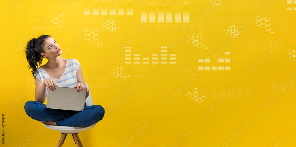 Digital graphs and hexagon grids with young woman using a laptop computer Digital graphs and hexagon grids with young woman using a laptop computer