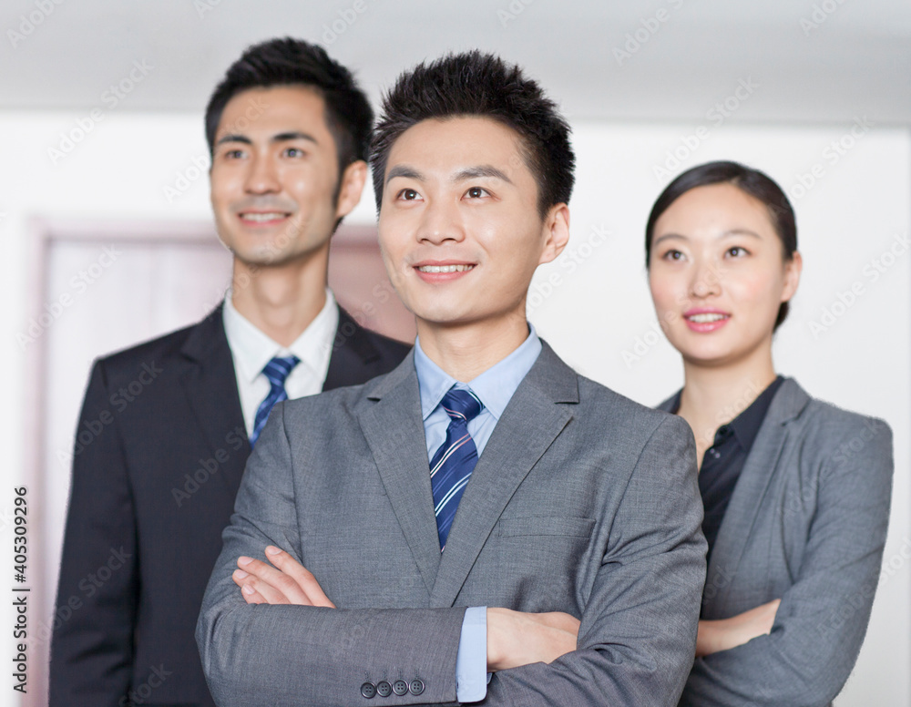 Four young office workers with hands crossed indoors,portrait Four young office workers with hands crossed indoors,portrait