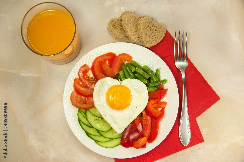 healthy breakfast with egg, bread, tomatoes, cucumber slice, bell pepper, green beans and a glass of juice for Valentine's day morning healthy breakfast with egg, bread, tomatoes, cucumber slice, bell pepper, green beans and a glass of juice for Valentine's day morning