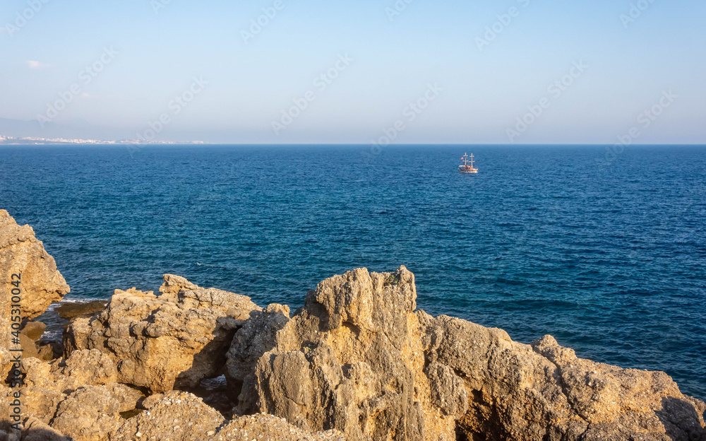 Scenic view of  sea, ship and rocks