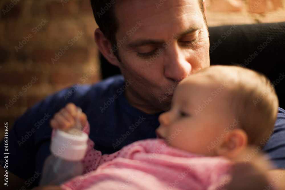 Father kissing baby daughter Father kissing baby daughter