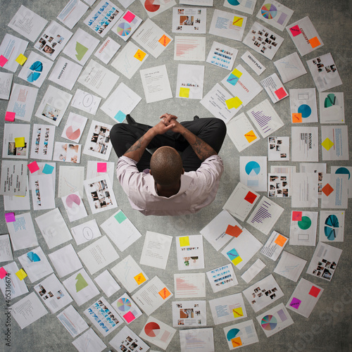 Businessman surrounded by papers