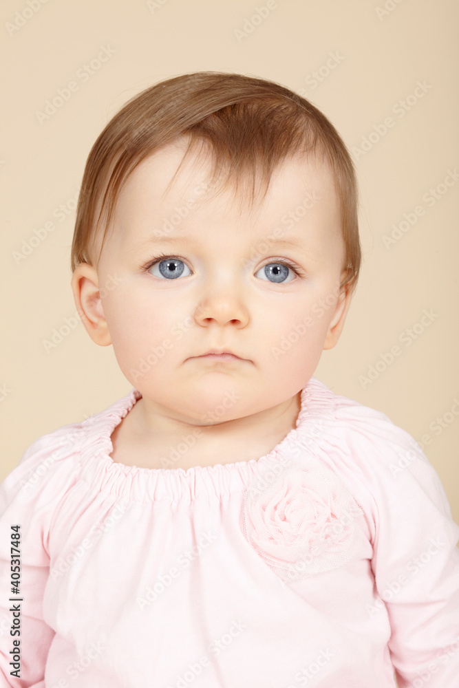 Close up studio portrait of baby girl with blue eyes