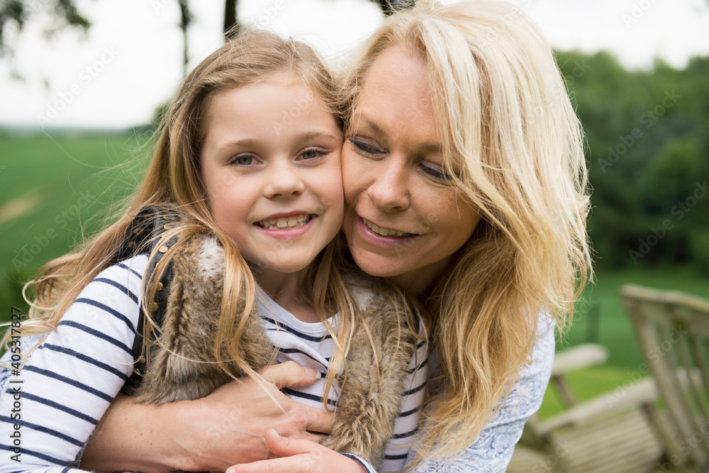 Mother hugging daughter, portrait Mother hugging daughter, portrait
