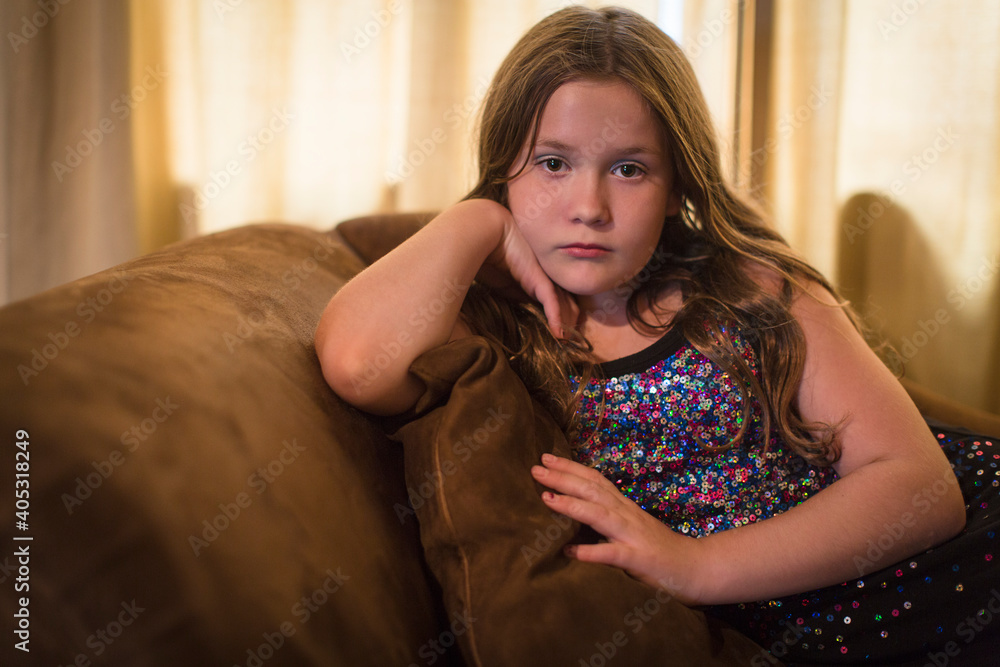 Portrait of sullen girl reclining on sofa Portrait of sullen girl reclining on sofa