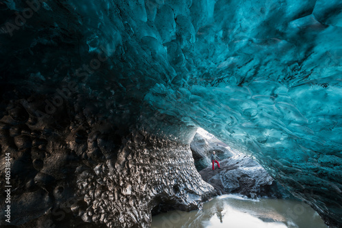 Mountain guide by entrance of Ice Cave, Sviafellsjokull outlet glacier, Southeast Iceland photo