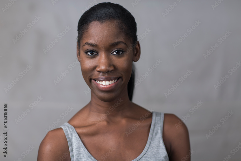 Portrait of young woman, smiling, studio shot Portrait of young woman, smiling, studio shot
