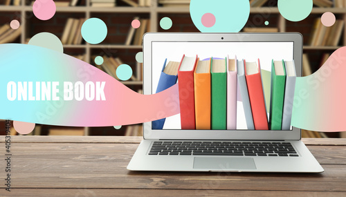 Modern laptop with books on...