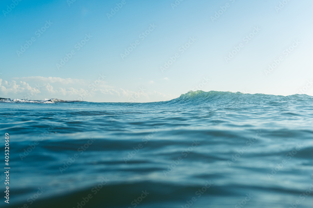Fototapeta premium Breaking Waves and spray, white water and light reflected on the surface of the water