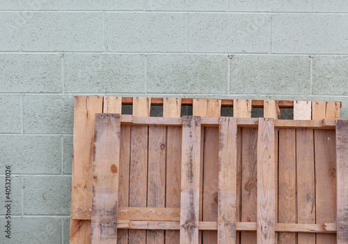 wooden pallets against brick wall