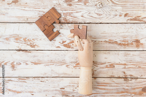 Wooden human hand with puzz...