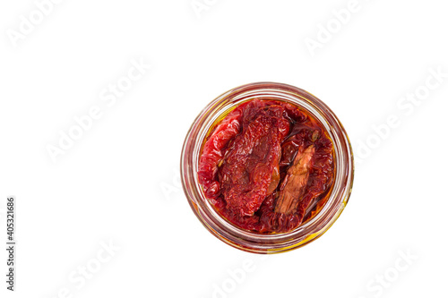 Sun-dried tomatoes in a glass jar isolated on a white background.