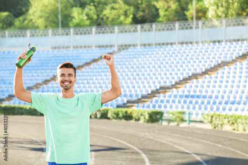 Sporty young man in stadium...