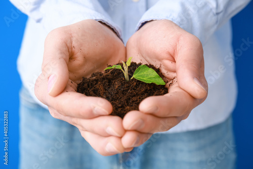 Male hands with soil and pl...