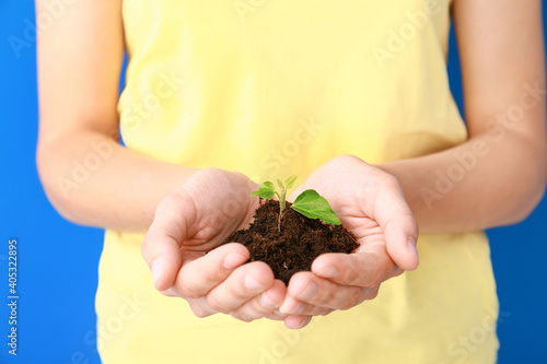 Female hands with soil and ...