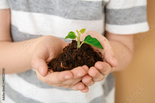 Child's hands with soil and...