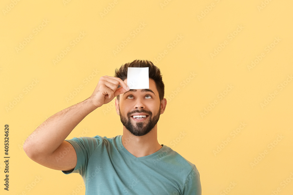 Man with blank note paper on color background Man with blank note paper on color background