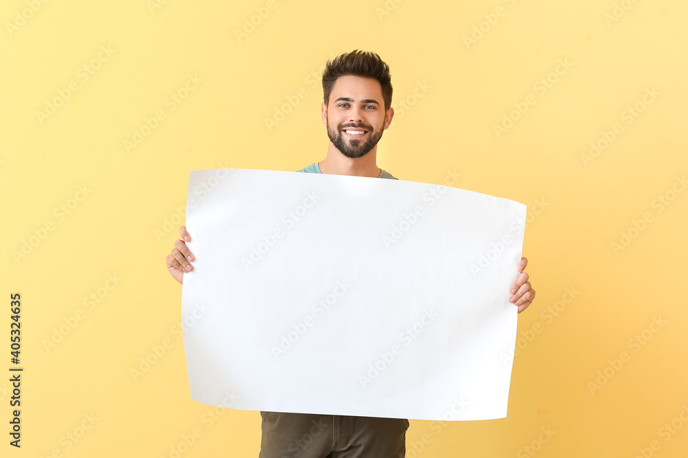 Young man with blank paper sheet on color background Young man with blank paper sheet on color background