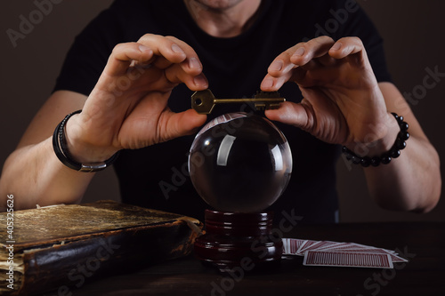 Fortune teller with crystal ball reading future at table