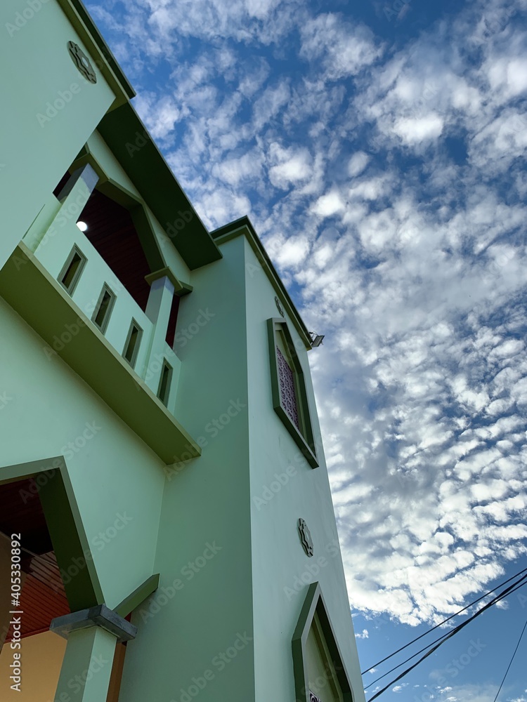building with blue sky and clouds