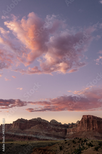 Cotton Candy Clouds Hang Over Rock Formations In Capitol Reef