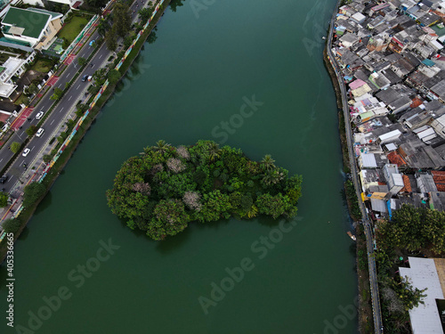 Aerial drone view of Beautiful Residential area and Green lake with Jakarta cityscape. JAKARTA, INDONESIA : JANUARY 14 2021