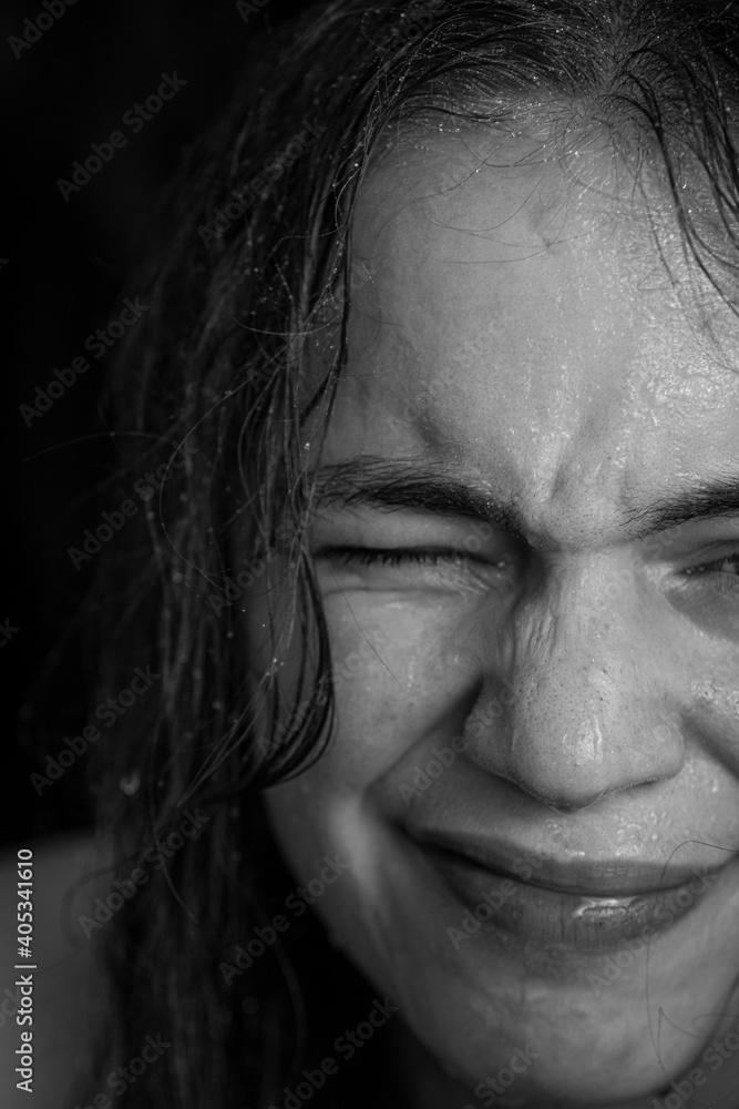 Woman Squinting with Water on Face Woman Squinting with Water on Face