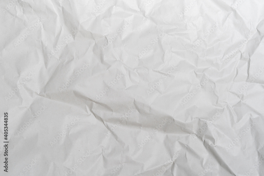 Crumpled white paper texture perfect for background structure. Packaging material with rough wrinkles. The grunge textured surface is a vintage backdrop.