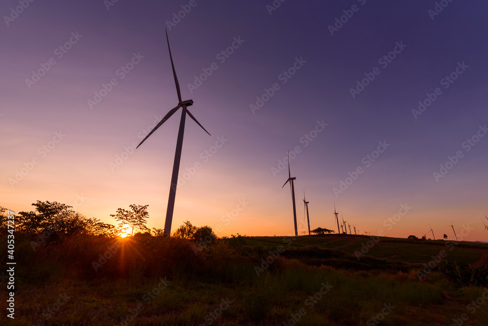 Obraz premium wind turbines park for make the electric power from wind in sunset time