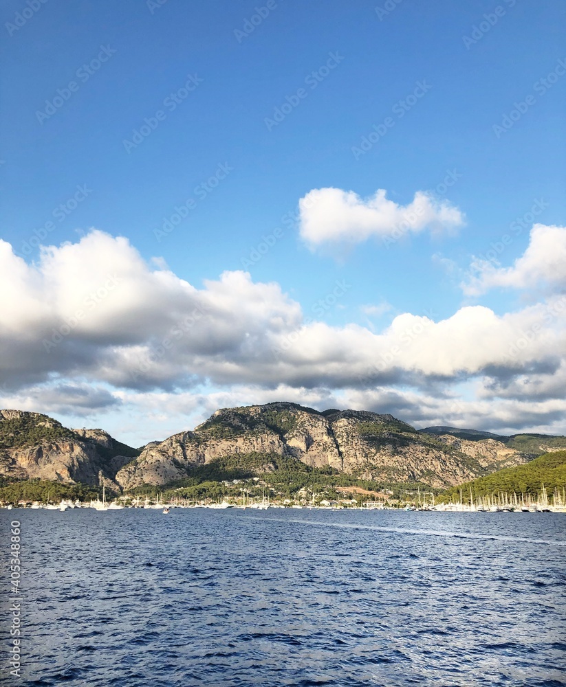 Beautiful Mediterranean sea and a mountain view in a portrait mode on a partially cloudy day