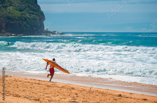 lifeguard run into the water photo