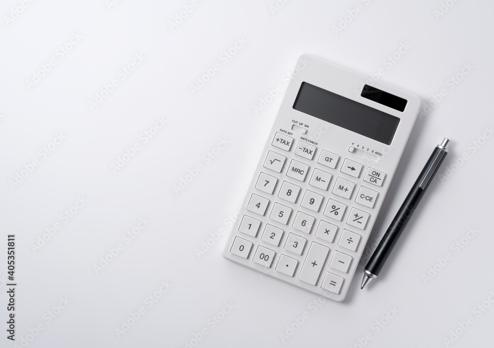 A calculator and pen on a white background A calculator and pen on a white background