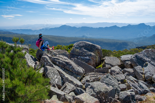 Woman with small backpack admiring the mountains view of Grampians, Australia