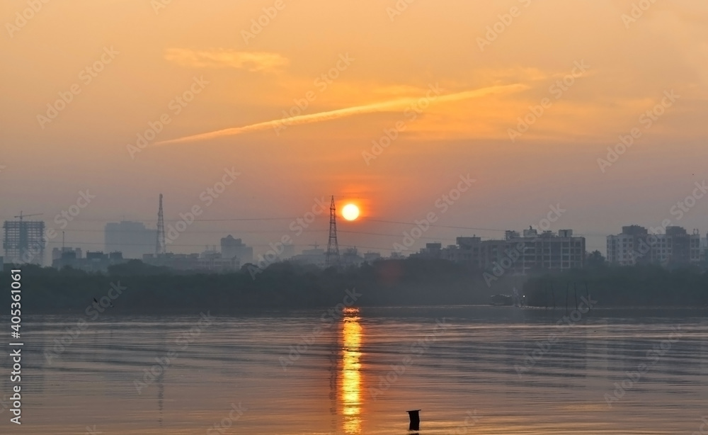 Beautiful sunrise view and reflection of sun in water with orange color