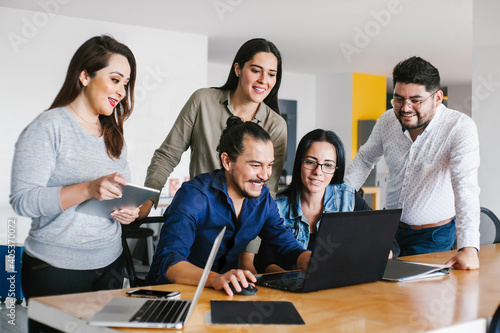 Photographie Group of latin business people working together as a teamwork while sitting at t