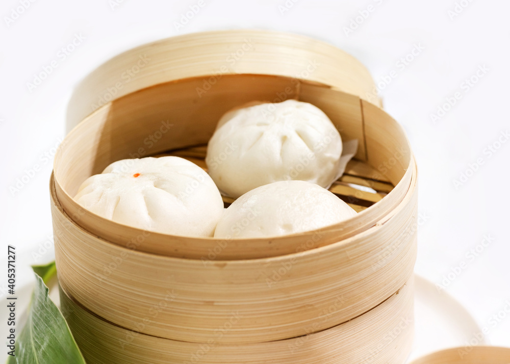 Chinese dumpling steamed buns, Steamed bun served in wooden basket Chinese dumpling steamed buns, Steamed bun served in wooden basket