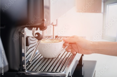 Coffee machine pours fresh espresso into the cups
