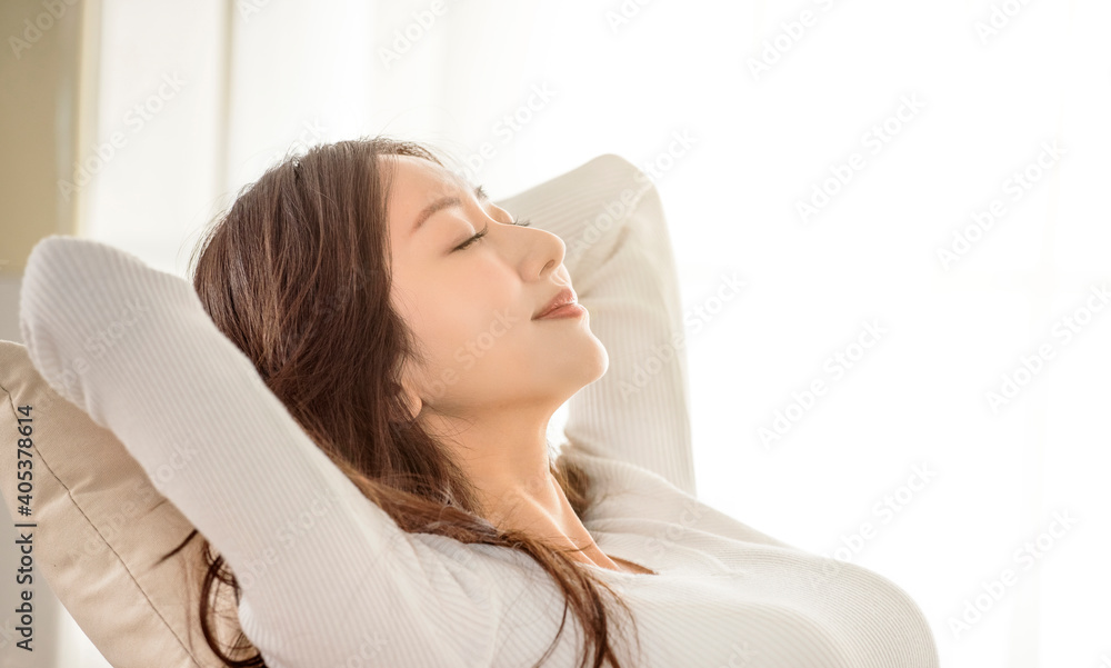 Relaxed young woman leaned on couch and closed eyes Relaxed young woman leaned on couch and closed eyes