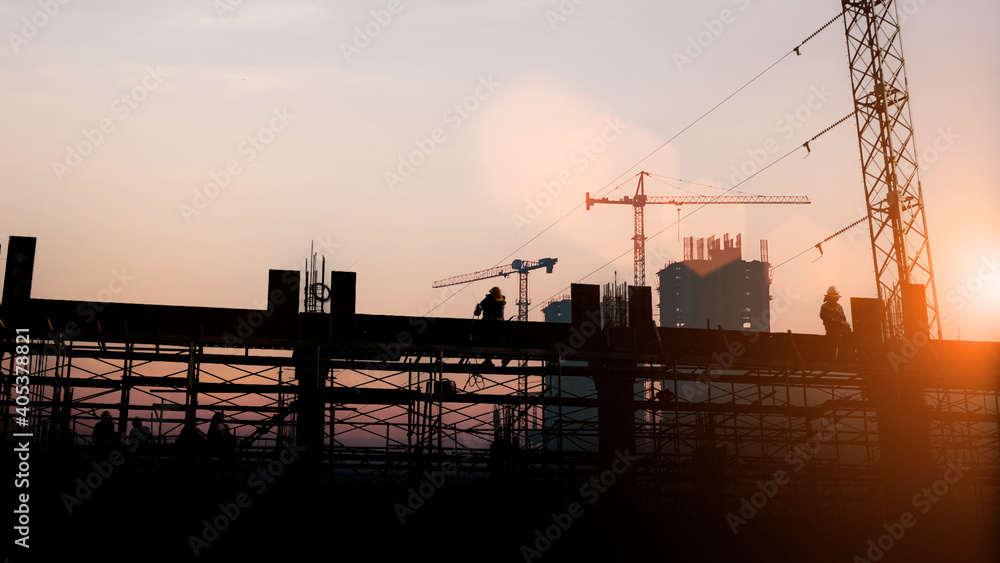 Silhouette Engineer and construction team working at site over blurred  industry background with Light fair Film Grain effect.