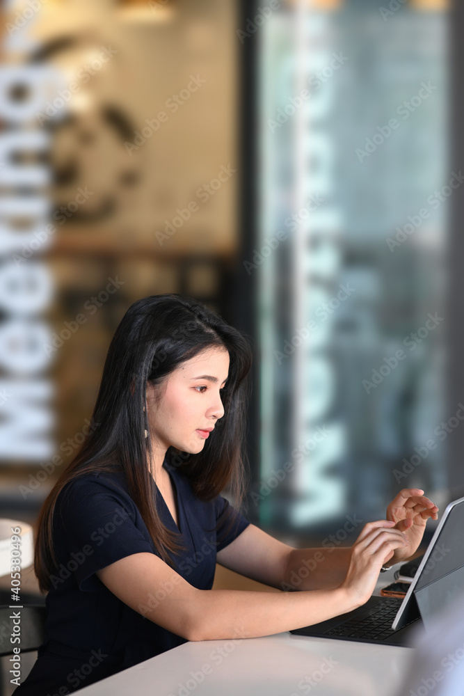 Portrait of businesswoman using tablet computer analyzing business data at her workplace. Portrait of businesswoman using tablet computer analyzing business data at her workplace.