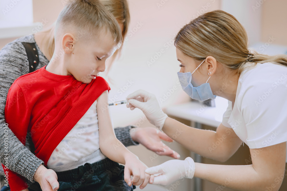 Little child medical visit. Doctor giving a child injection in arm. Little child medical visit. Doctor giving a child injection in arm.