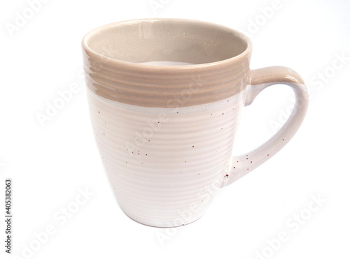 The empty beige color of coffee or tea mug isolated on a white background. Drink design concepts..