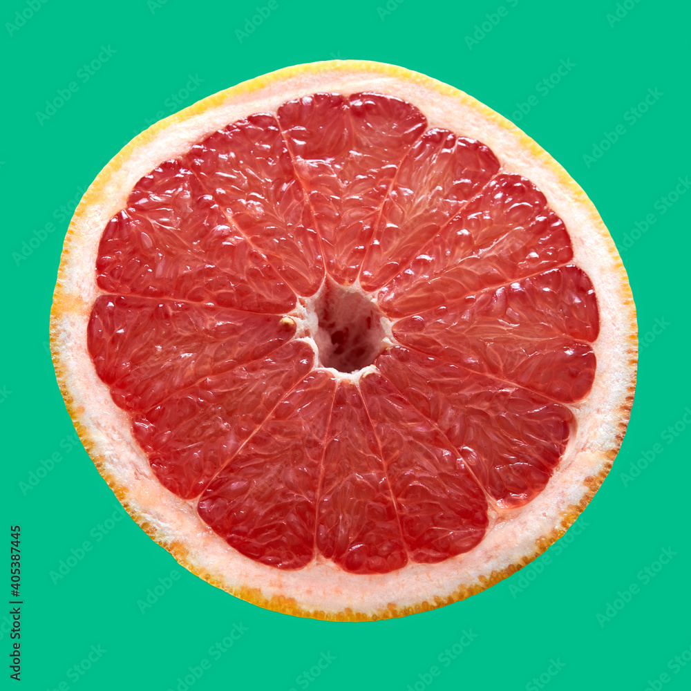 red grapefruit lies on a red background red grapefruit lies on a red background