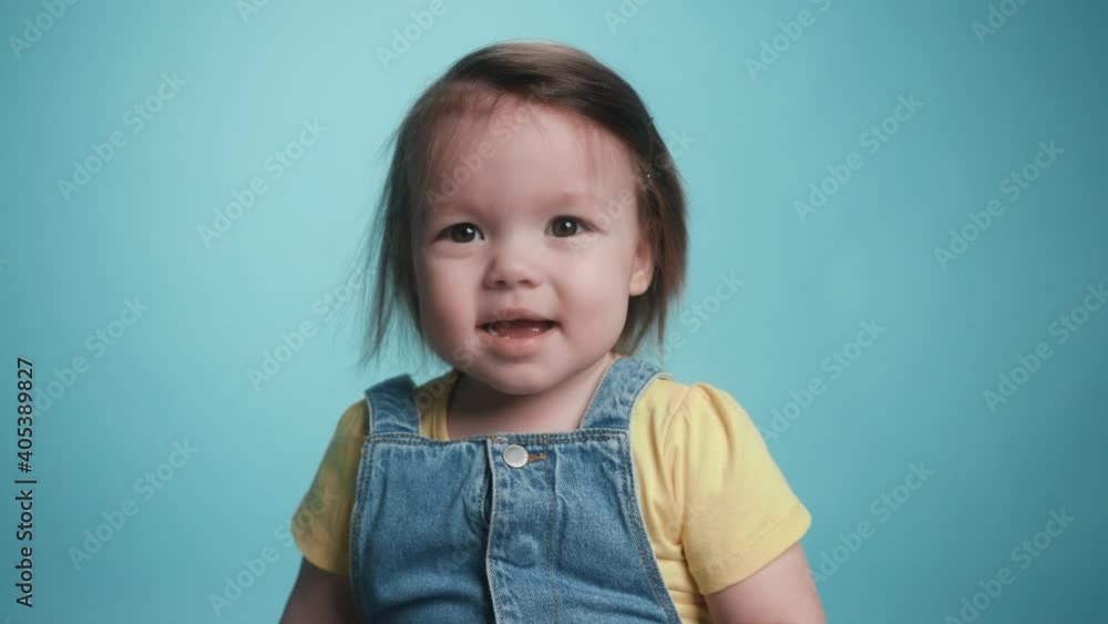 Close-up Portrait Smiling Little Girl Kid Looking at Camera. Funny Playful Laugh of Little Cute Girl Child. Expressive Cheerful Adorable Kids Face. Concept of a Fun Childhood. Slow Motion Studio Shot Close-up Portrait Smiling Little Girl Kid Looking at Camera. Funny Playful Laugh of Little Cute Girl Child. Expressive Cheerful Adorable Kids Face. Concept of a Fun Childhood. Slow Motion Studio Shot