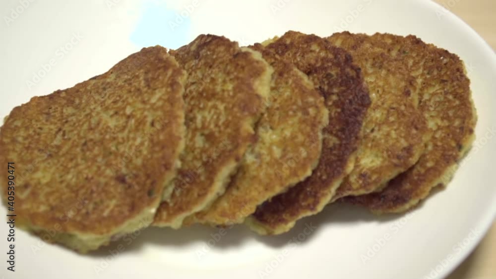 Ready potato pancakes are on the plate. Close-up. Dranik, Russian traditional food. Side view Ready potato pancakes are on the plate. Close-up. Dranik, Russian traditional food. Side view
