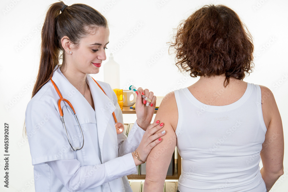 Doctor female giving Covid vaccine to senior woman intramuscular injection in female arm Doctor female giving Covid vaccine to senior woman intramuscular injection in female arm