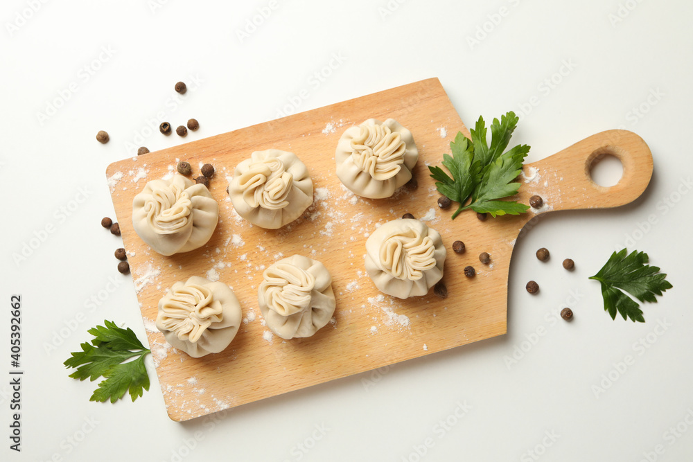 Board with khinkali, spices and flour on white background Board with khinkali, spices and flour on white background