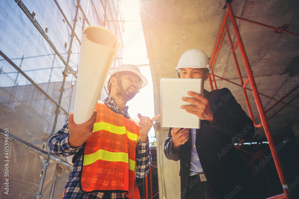 Structural engineer and foreman worker with blueprint discuss, plan working for building construction site. Structural engineer and foreman worker with blueprint discuss, plan working for building construction site.